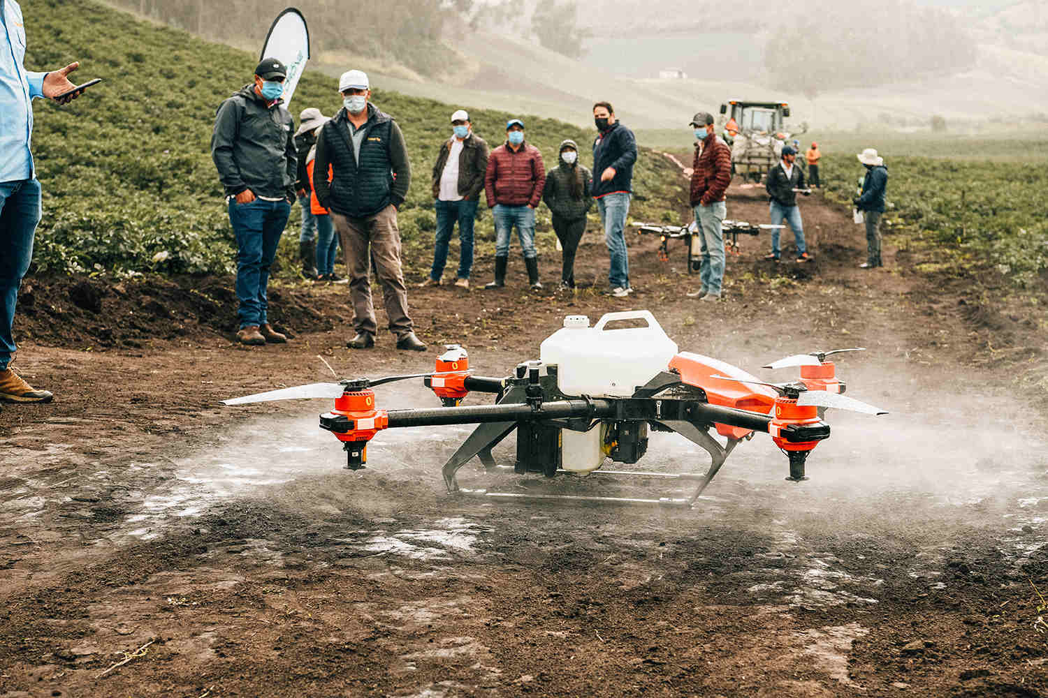  Ecuadorian farmers watch XAG's drone spraying crops for the first time