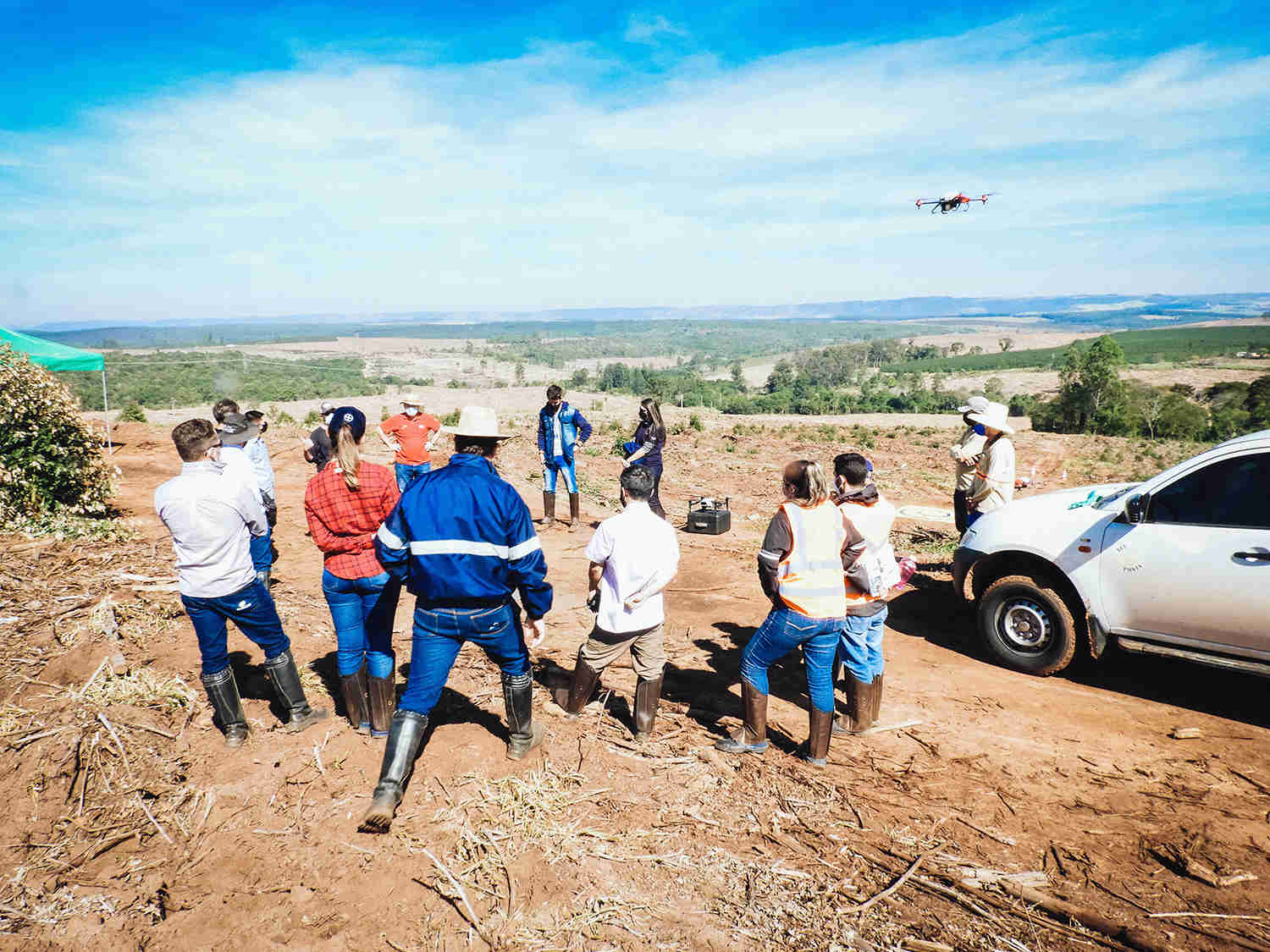 Plantation managers and experts witnessing the XAG agricultural drone fleet spraying (Source: Tecponta)