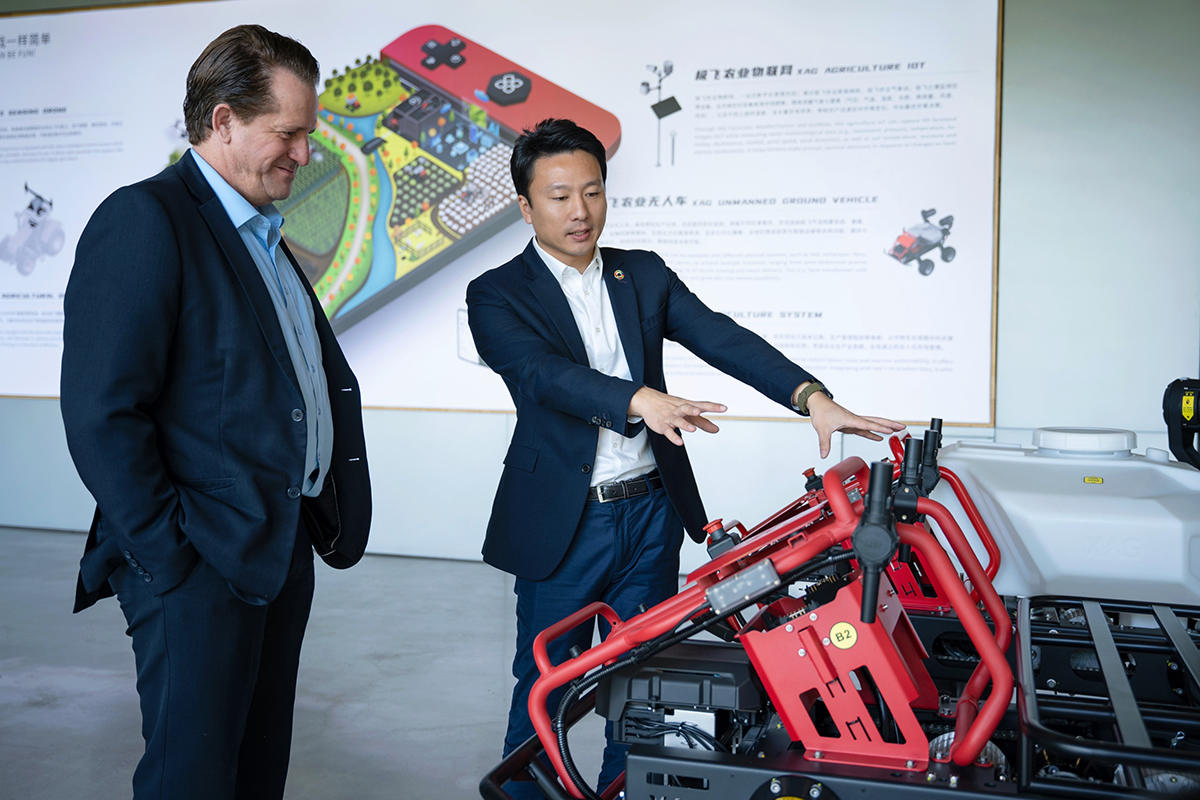 Justin Gong explaining the technology of XAG R150 Farm Robot to Mr. Watson
