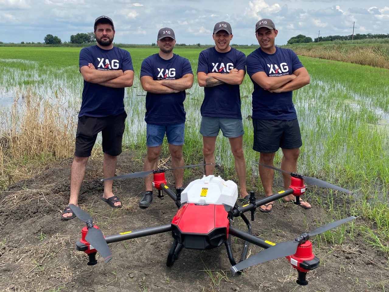 XAG drone pilots working beside the rice paddy