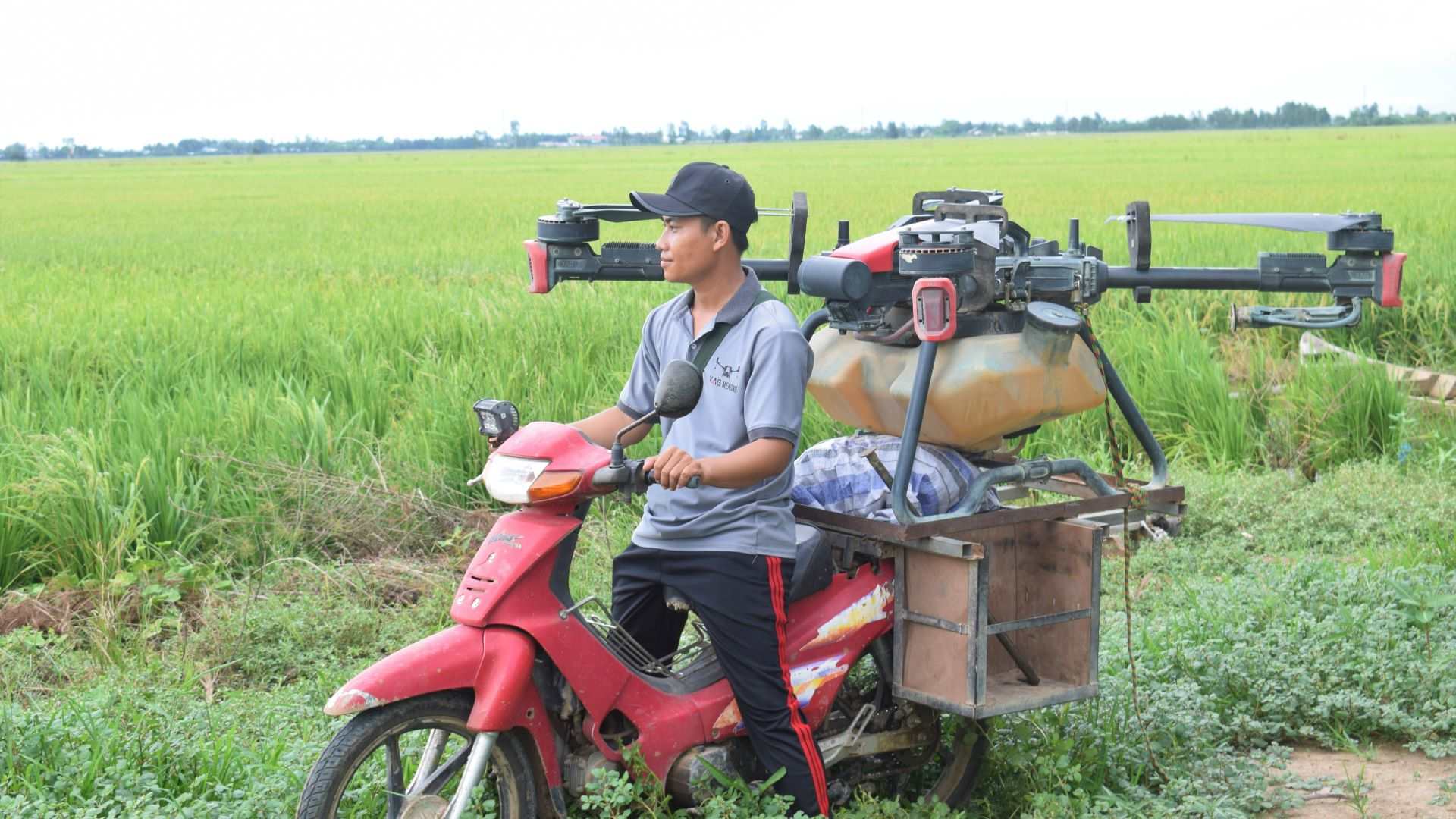 A Vietnamese user of XAG P100 Agricultural Drone carrying the drone with a motorcycle